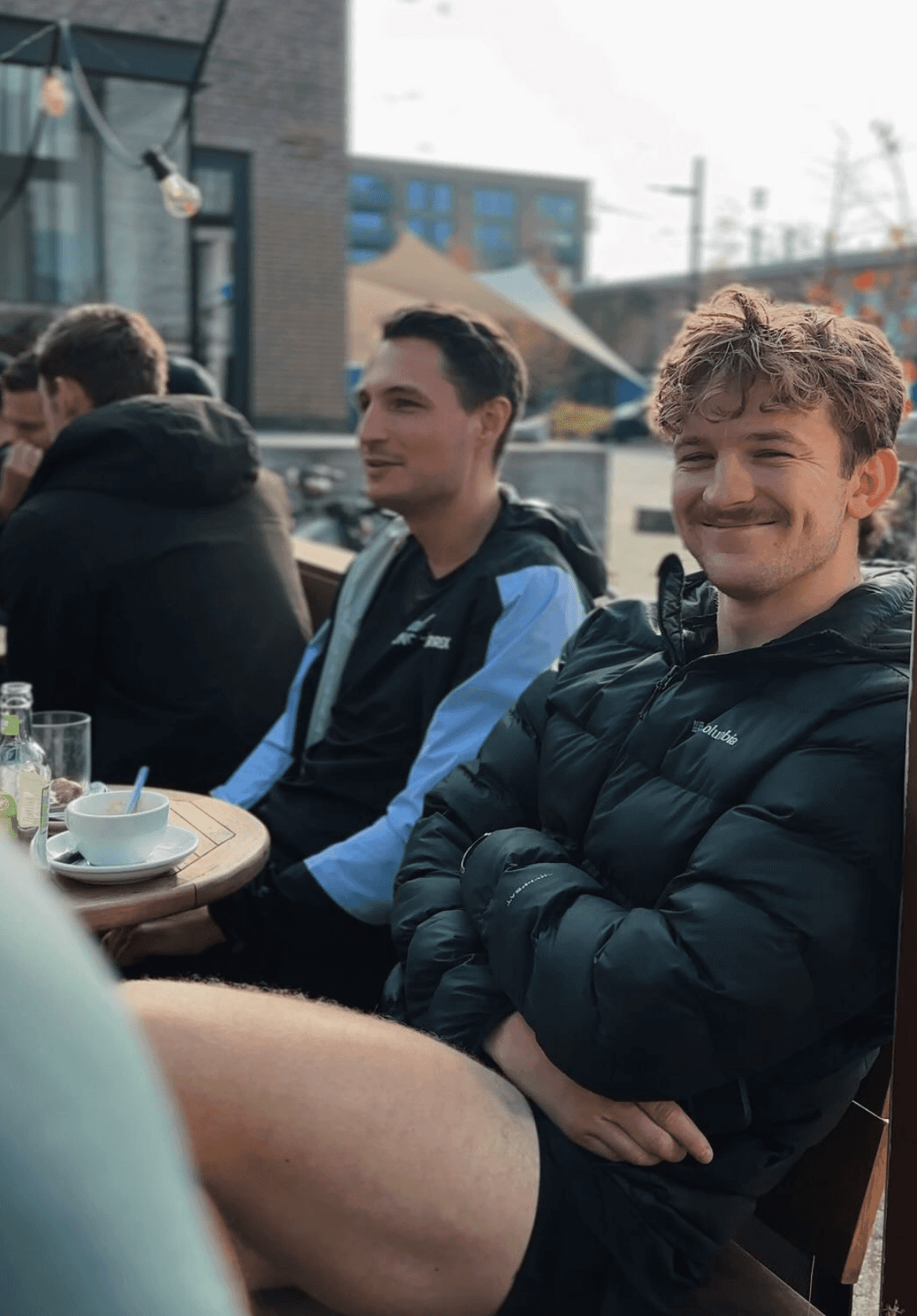 Post-run vibes - social run club members relaxing and chatting after a run in Eindhoven